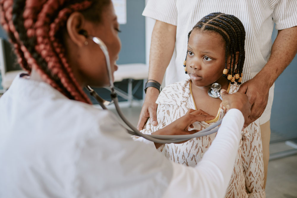 Healthcare provider examining a young child during a checkup at InterCommunity Health Care.